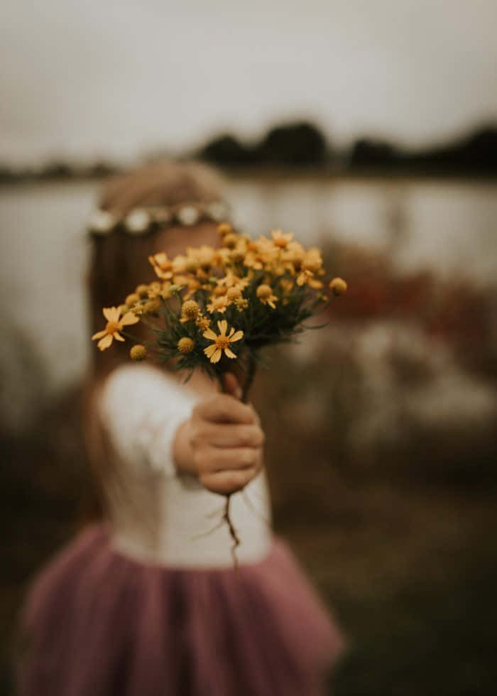 Emotion Girl Holding A Yellow Flowers Picture