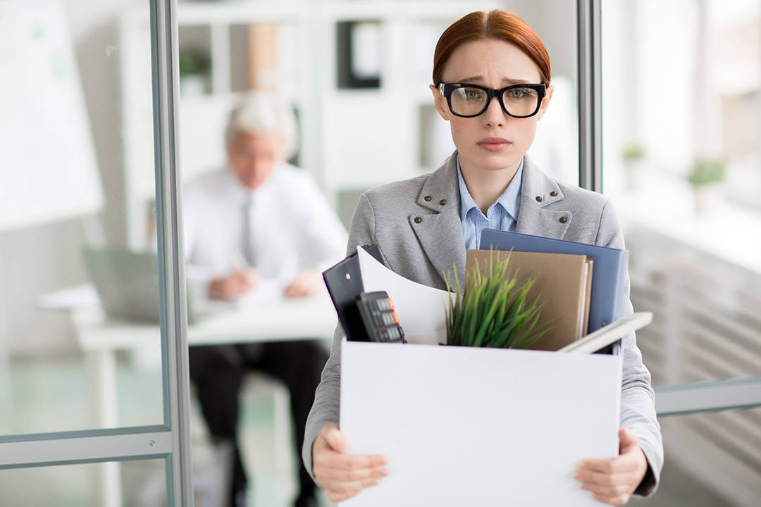 Employee Leaving Office With Belongings Wallpaper