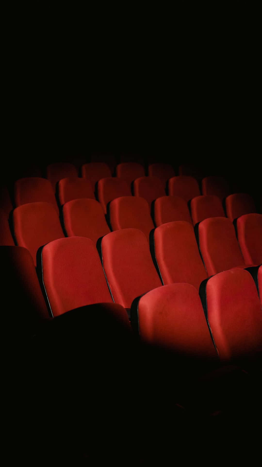Empty Cinema Seatsin Darkness Wallpaper