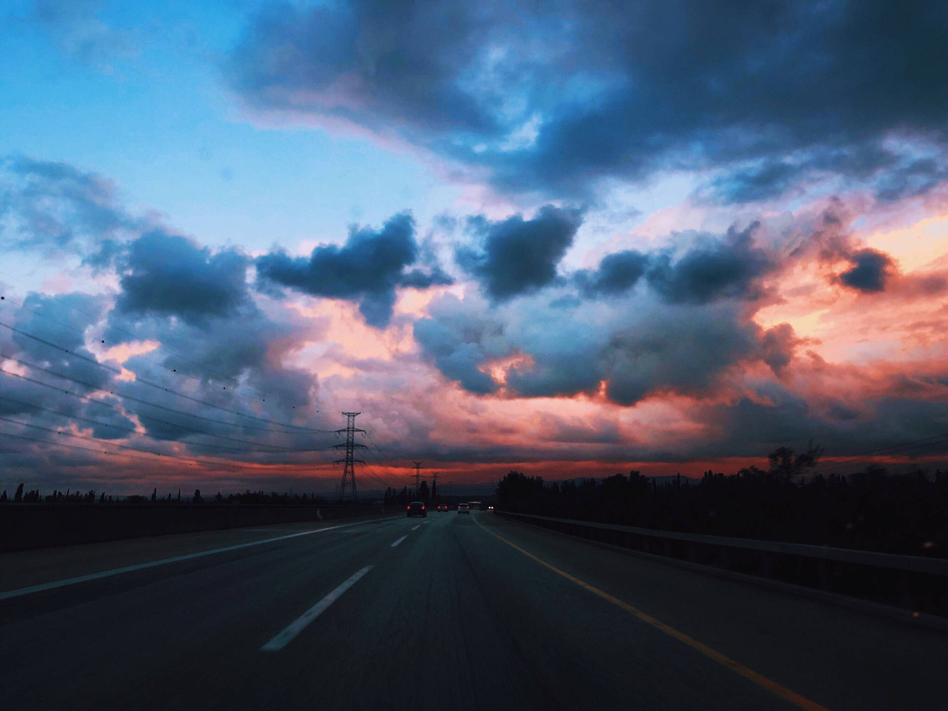 Empty Road With Dark Blue Clouds Wallpaper
