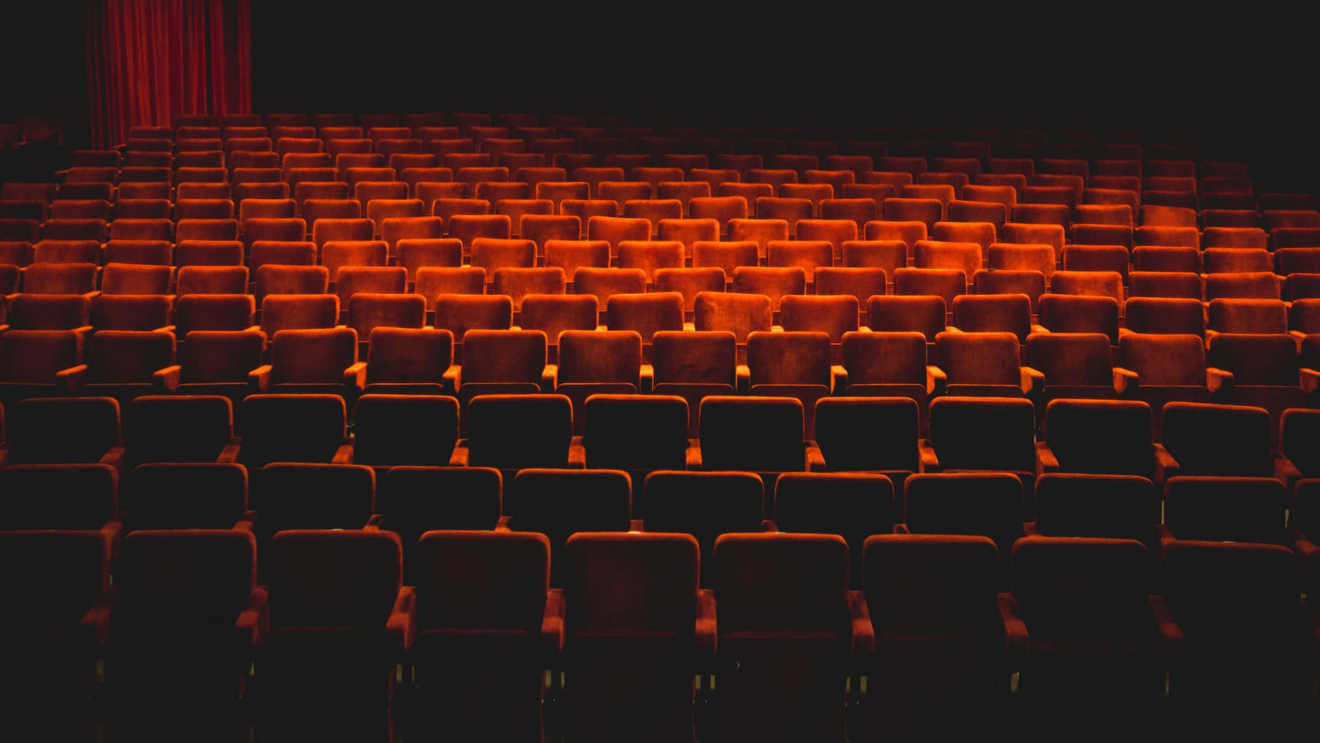 Majestic Empty Theater With Red Chairs Wallpaper