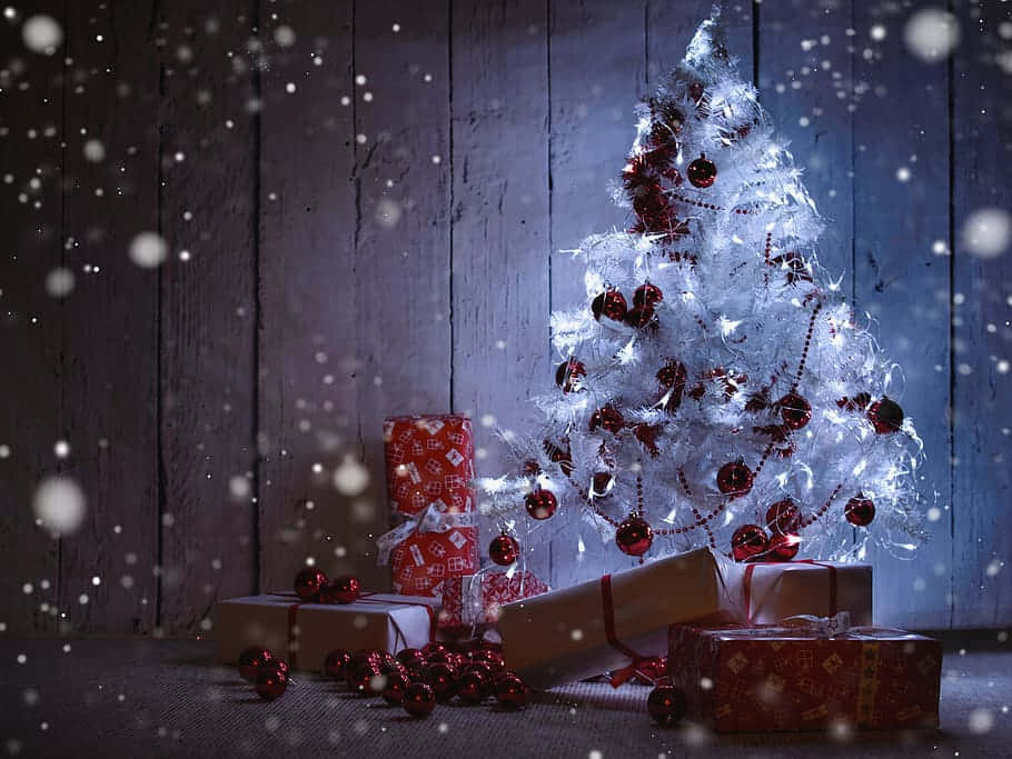 Enchanted White Christmas Treewith Gifts Wallpaper