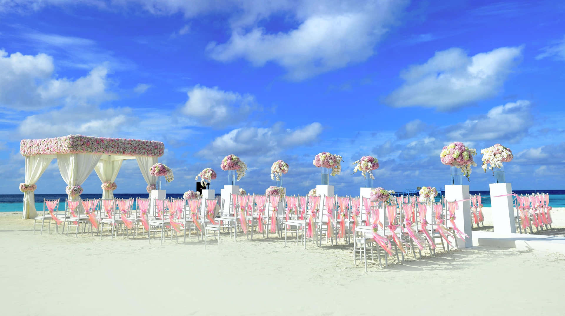 Enchanting Beach Wedding Ceremony At Dusk Wallpaper