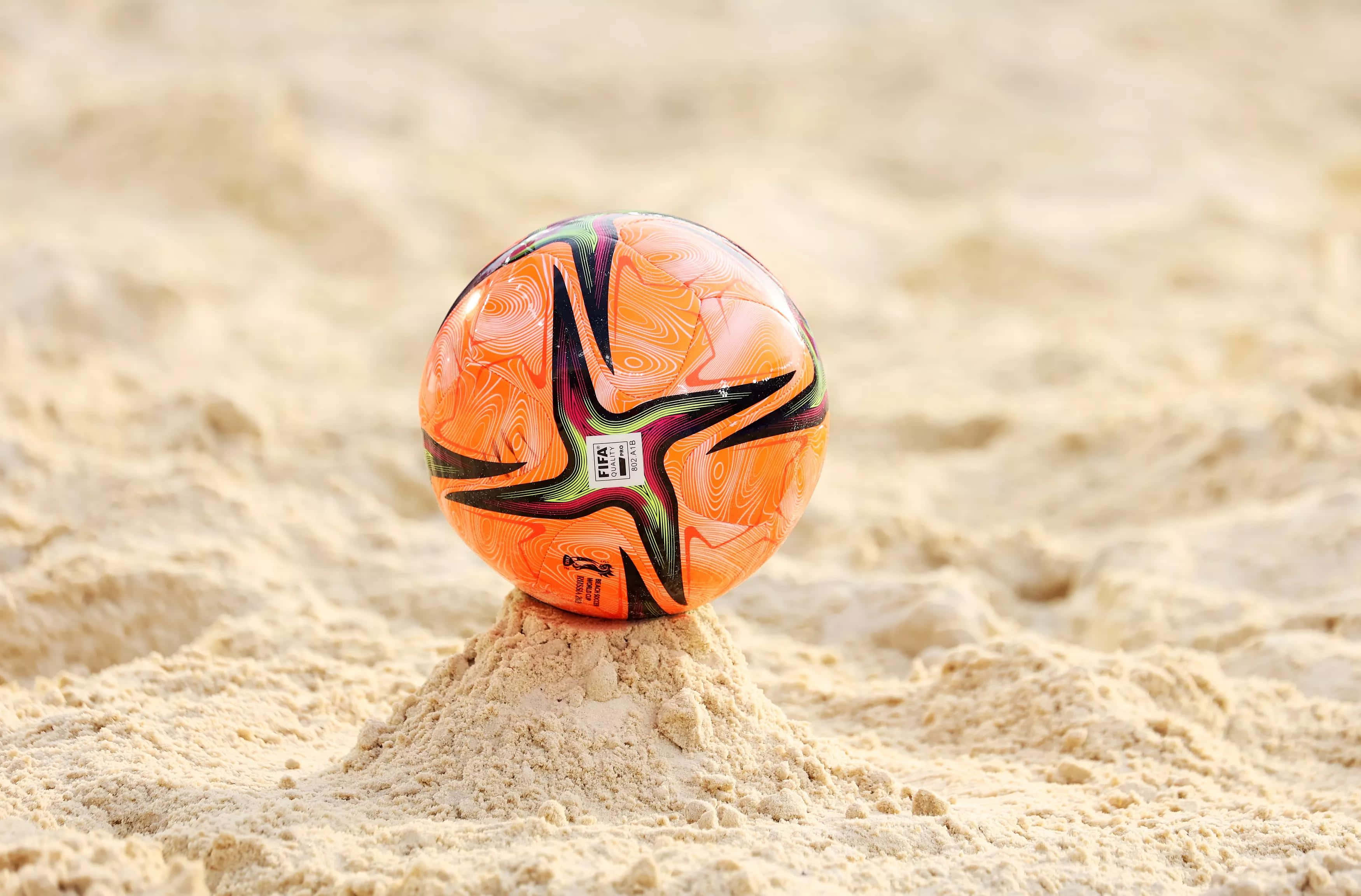 Energetic Beach Soccer Game In Action Wallpaper