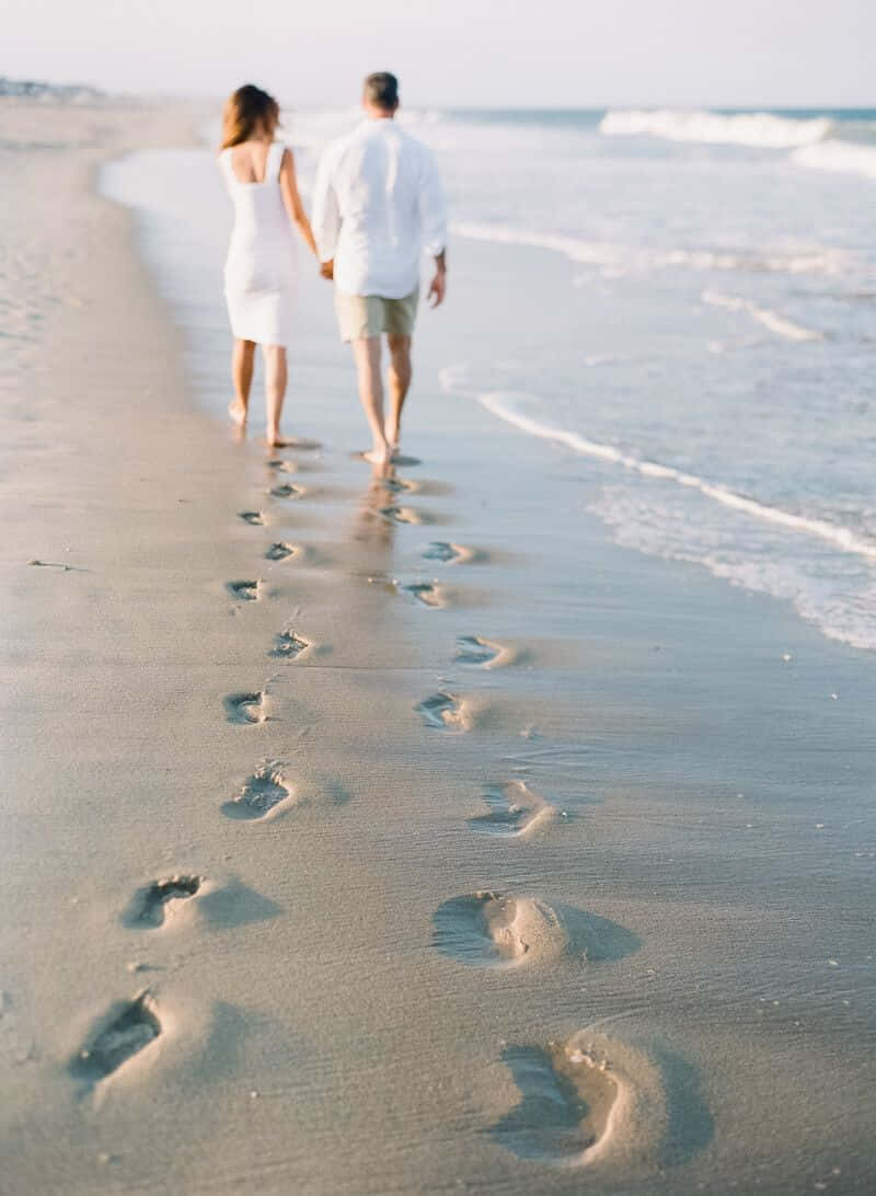 Engagement Couple On Beach With Footprints Pictures