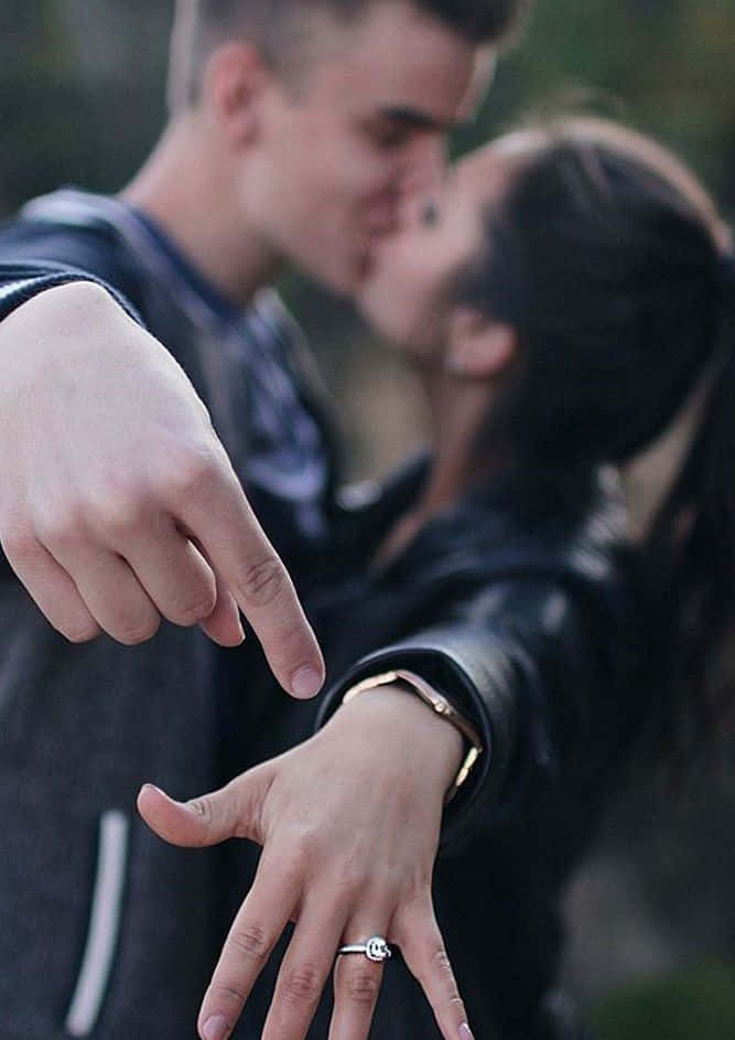 Engagement Cute Couple In Black Jackets Kissing Pictures