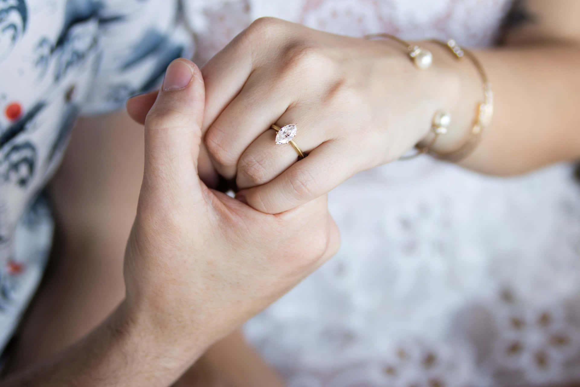 Couple Holding Hands With Engagement Ring Picture