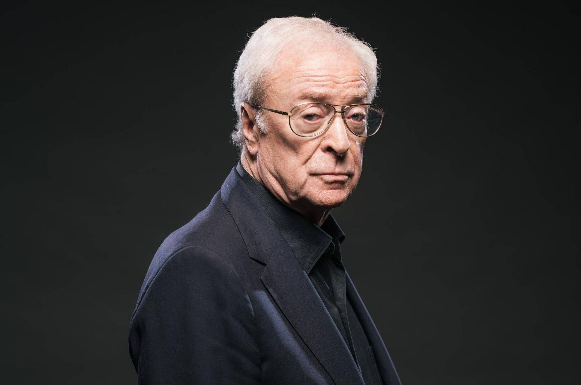 English Actor Michael Caine In Black Suit Wallpaper