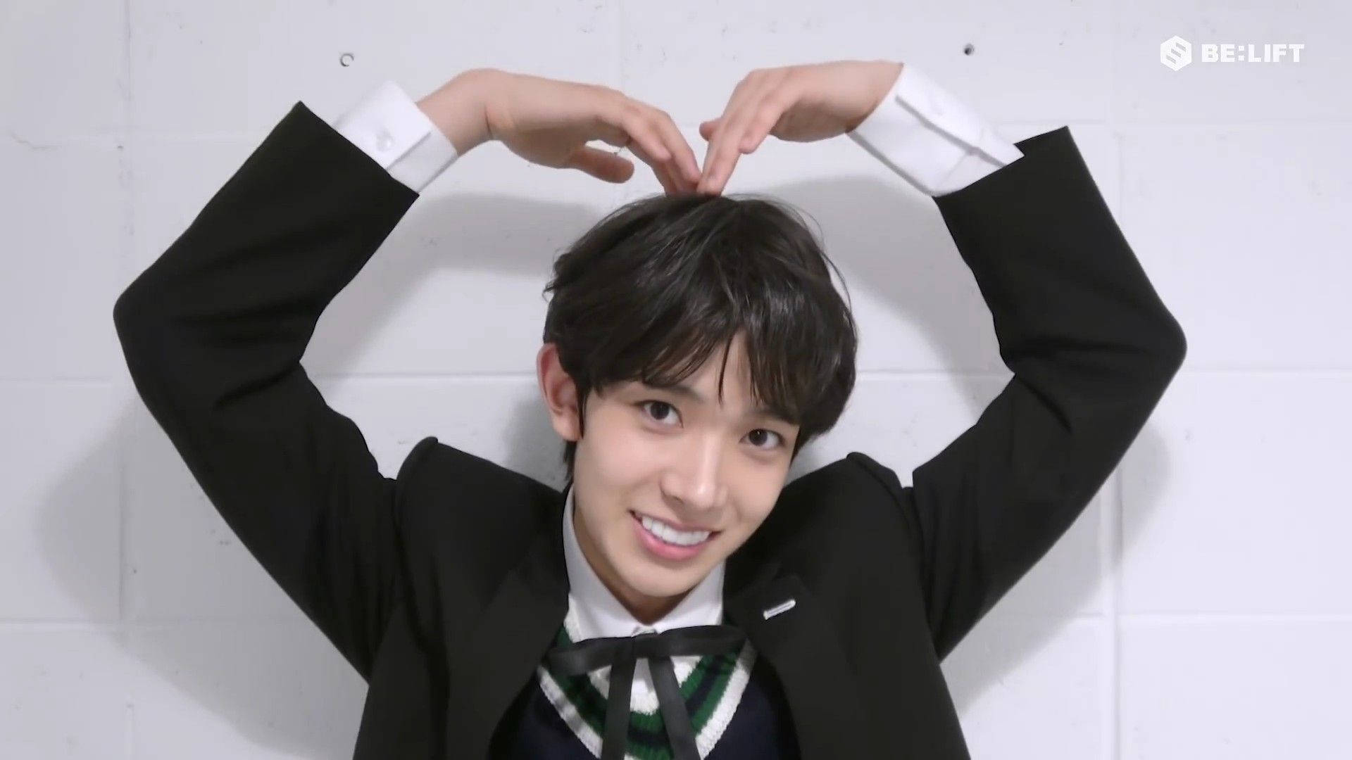 Enhypen Heeseung Doing A Heart Pose Background