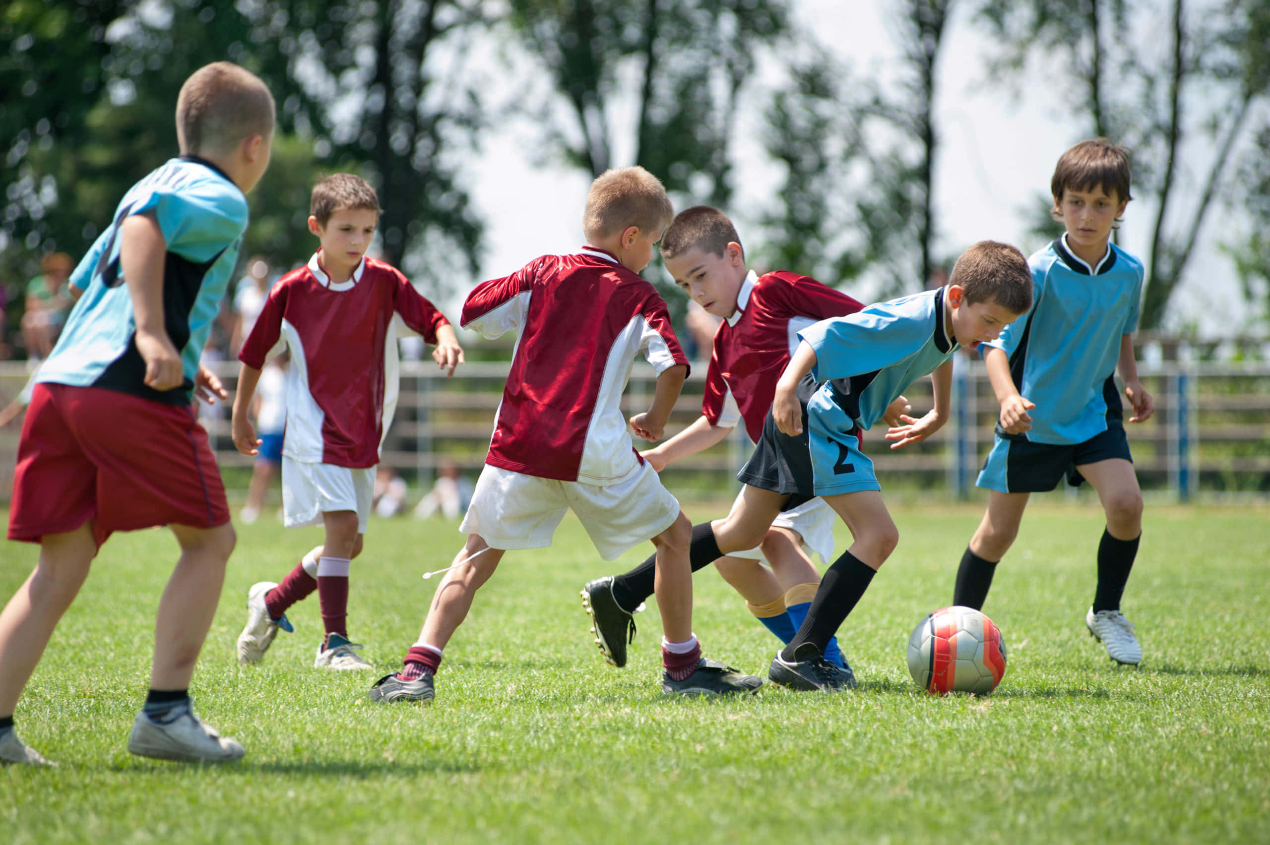 Enthusiastic Young Soccer Players In Action Wallpaper