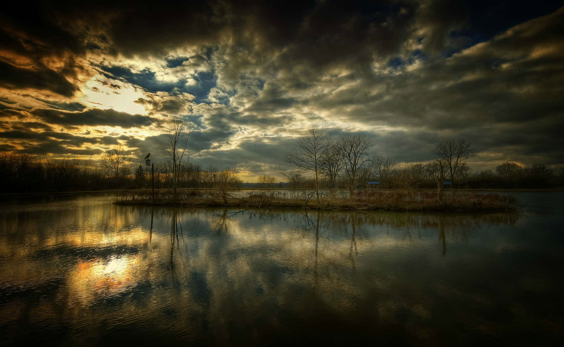A Lake With Clouds And Trees In The Background Wallpaper