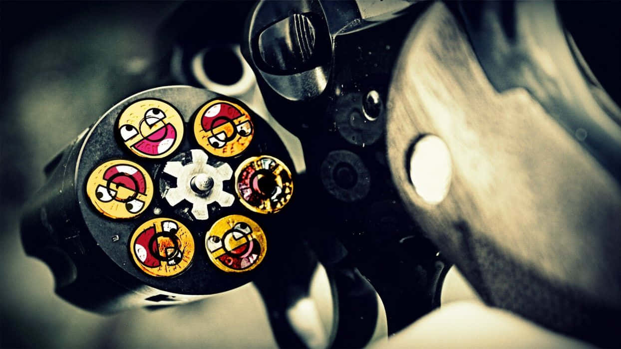 A Gun With A Lot Of Stickers On It Wallpaper