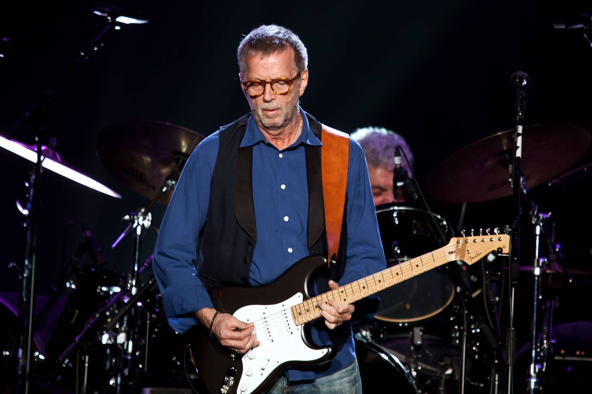 Eric Clapton Performing On Stage Wallpaper