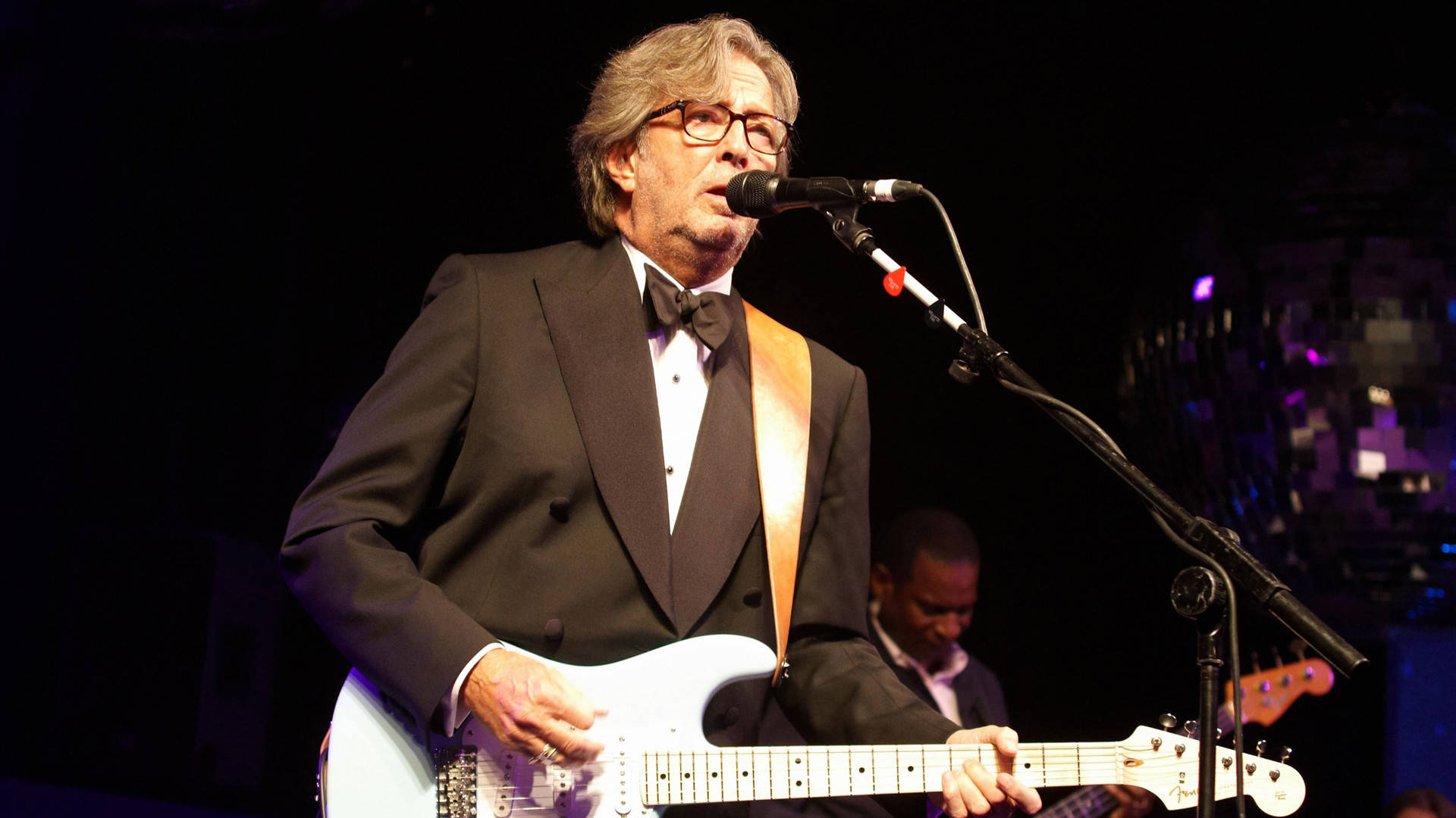 Eric Clapton Playing Guitar In Tuxedo Wallpaper