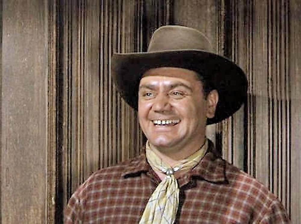 Ernest Borgnine Smiling In A Brown Plaid Shirt Wallpaper