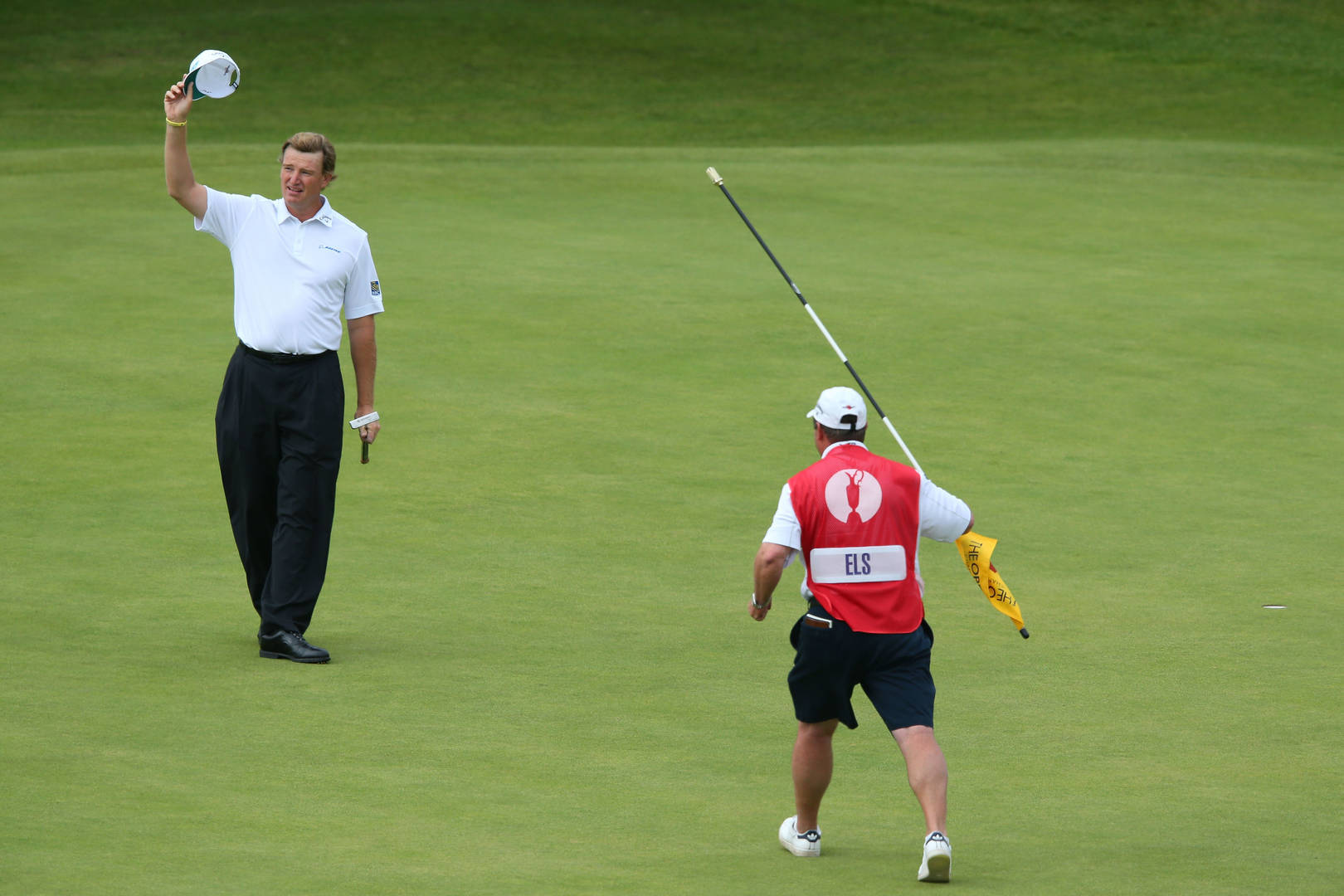 South African Pro Golfer Ernie Els with His Caddy on the Golf Course Wallpaper