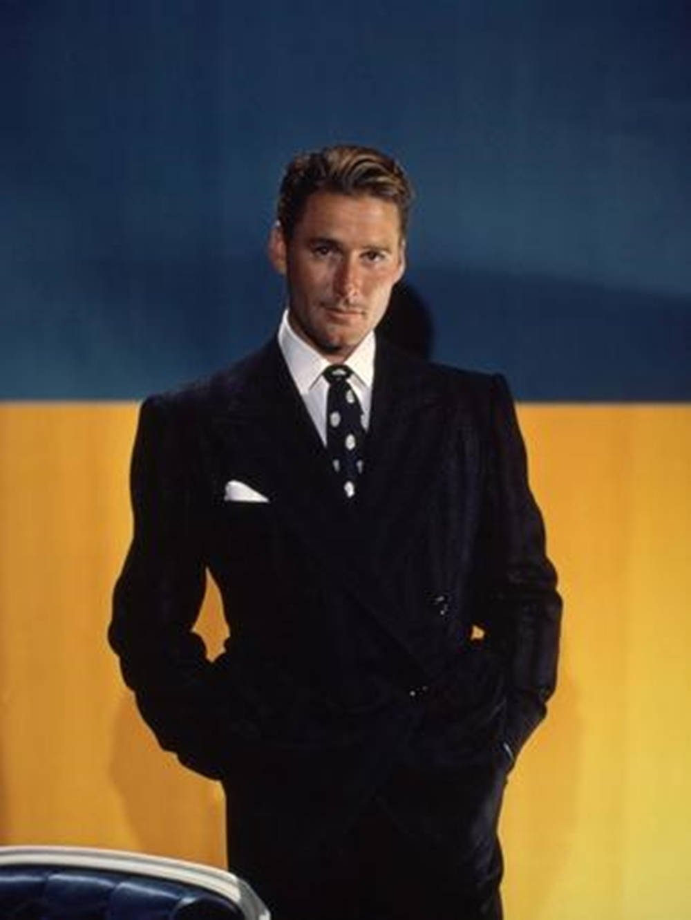 Errol Flynn In Suit Blue And Yellow Background Wallpaper