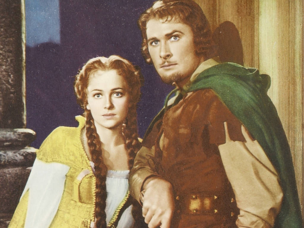 Denne tapet afbilder Errol Flynn og Olivia De Havilland i deres roller fra Robin Hood filmen og ser virkelig sød ud. Wallpaper