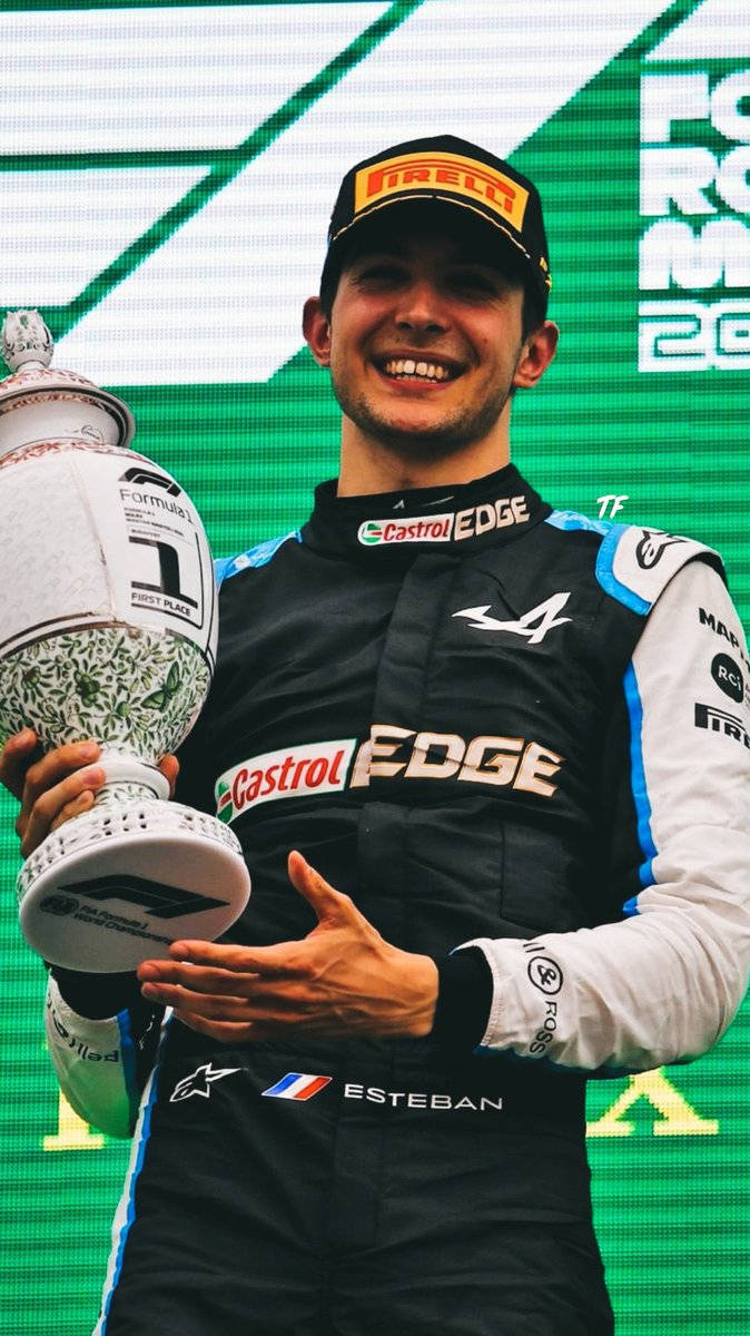 Esteban Ocon Holding Race Trophy Wallpaper