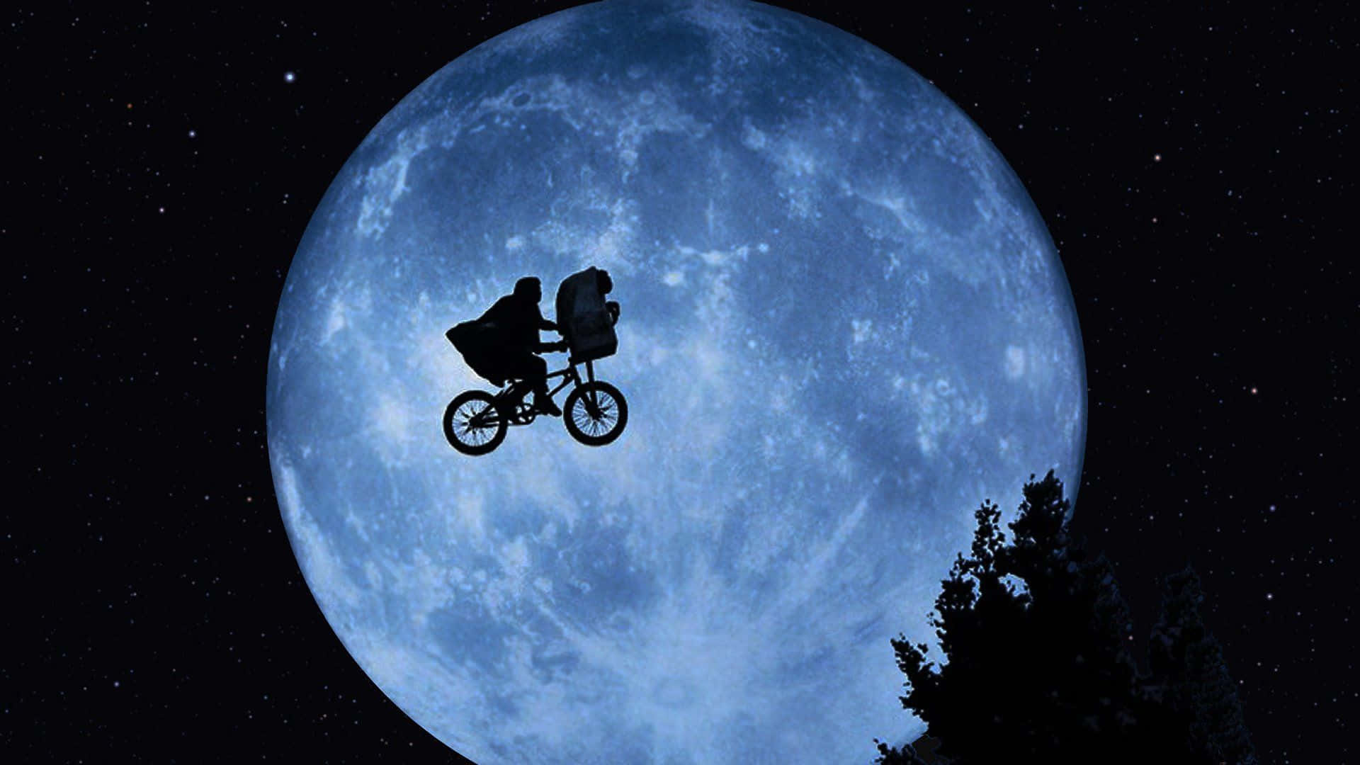 a man riding a bike in front of a full moon