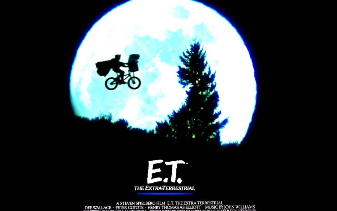 et the movie poster with a man riding a bike in the sky