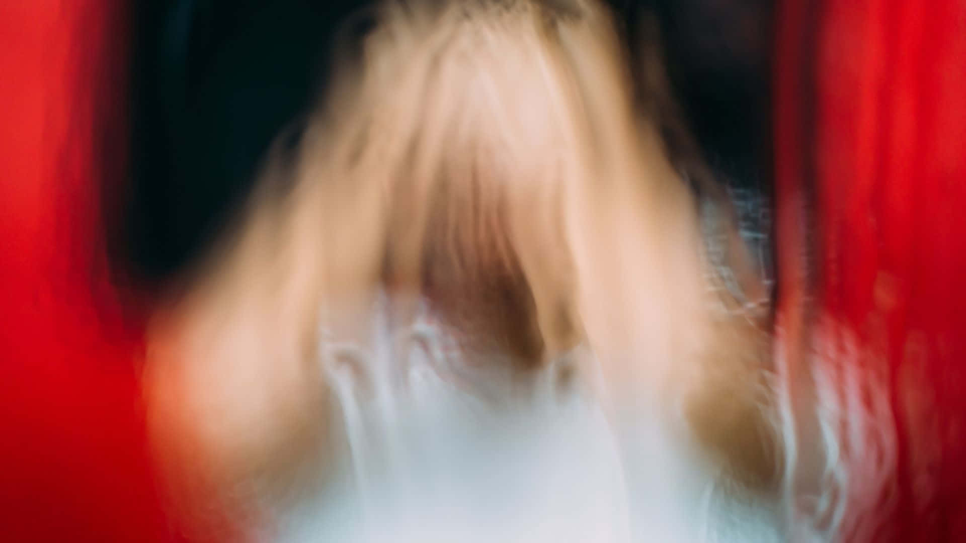 Ethereal Figure In Red Blur Wallpaper