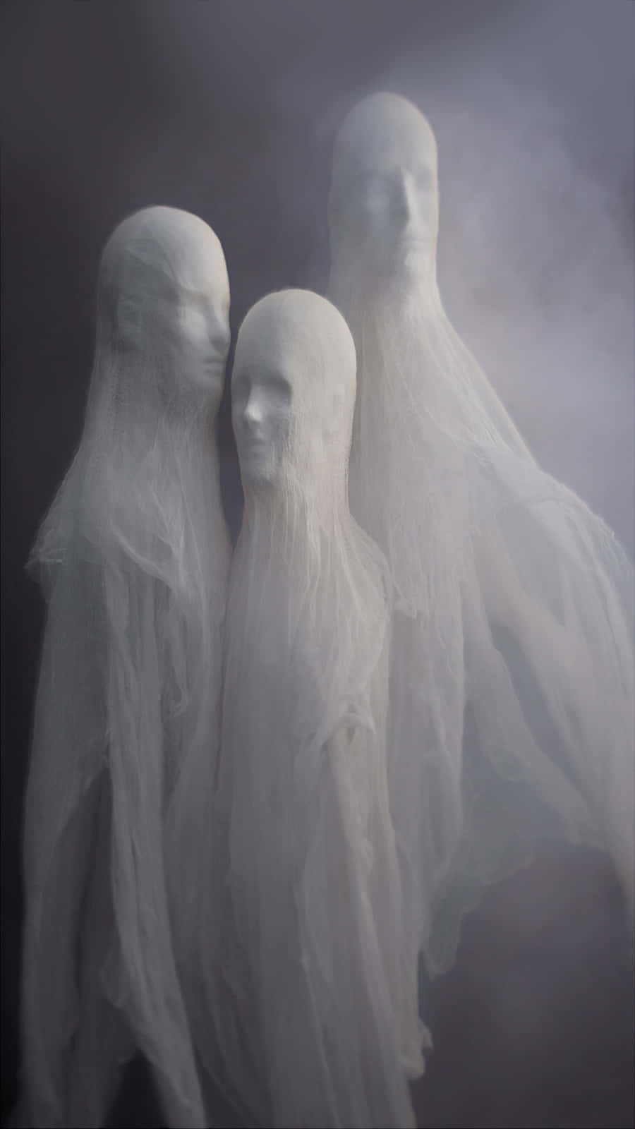 Ethereal Ghostly Figures Shroudedin Mist Wallpaper