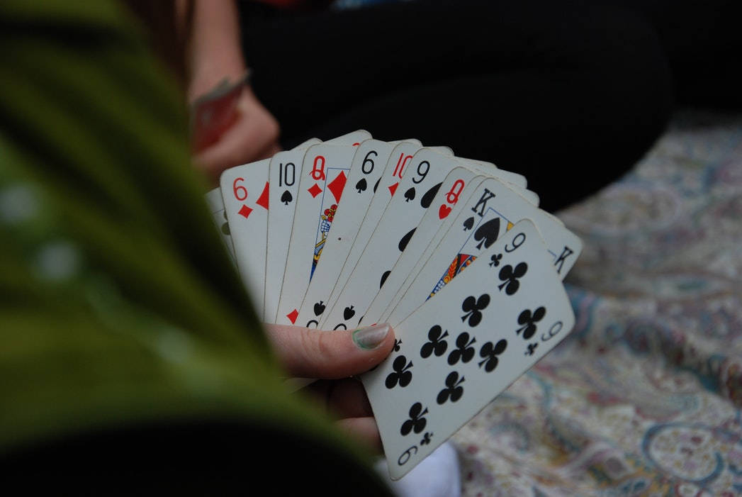 Caption: Euchre Player's Hand with Deck Wallpaper