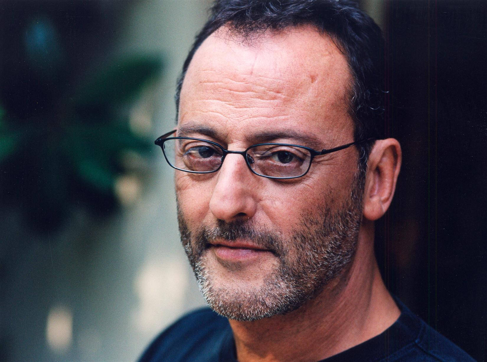 Iconic French actor Jean Reno poses pensively. Wallpaper