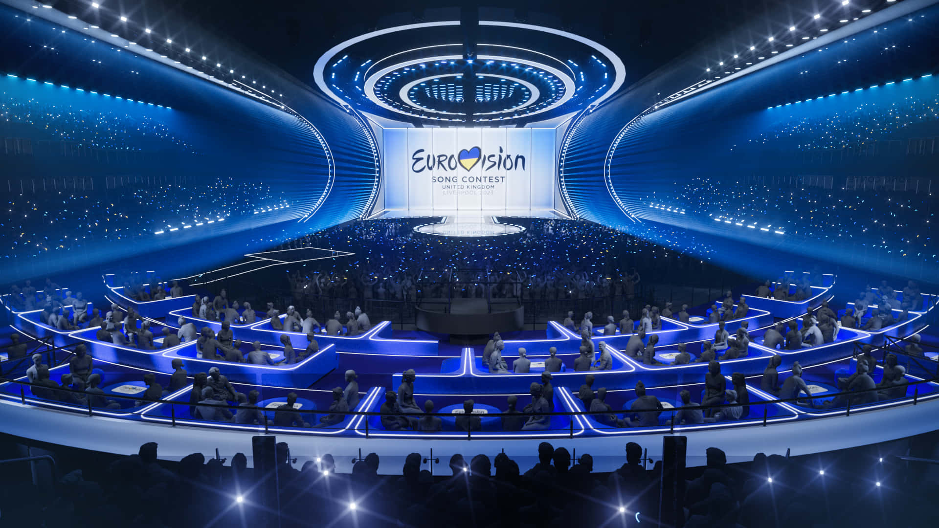 A Large Stage With Blue Lights And People In It Wallpaper