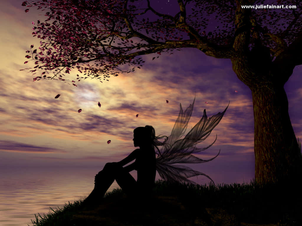 Fairy Sitting Under A Tree At Sunset Wallpaper