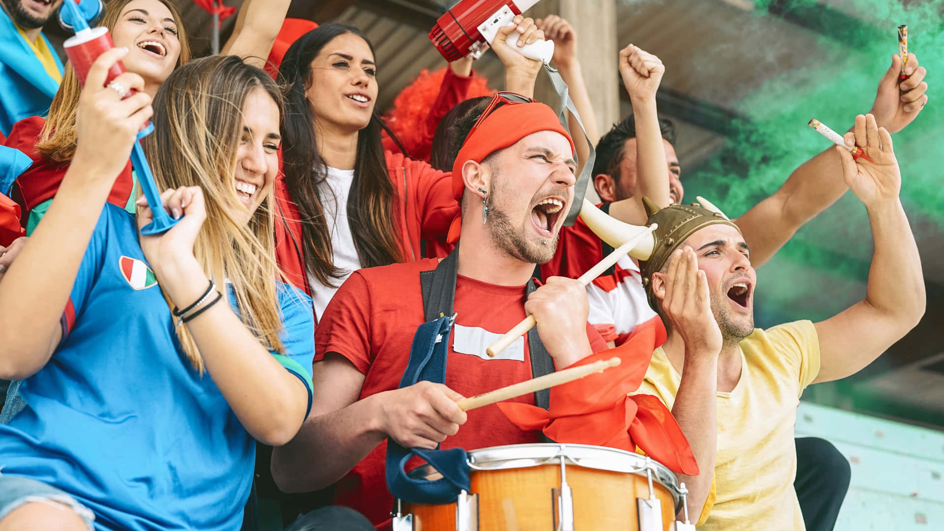 Excited Sports Fans Celebratingat Stadium Wallpaper