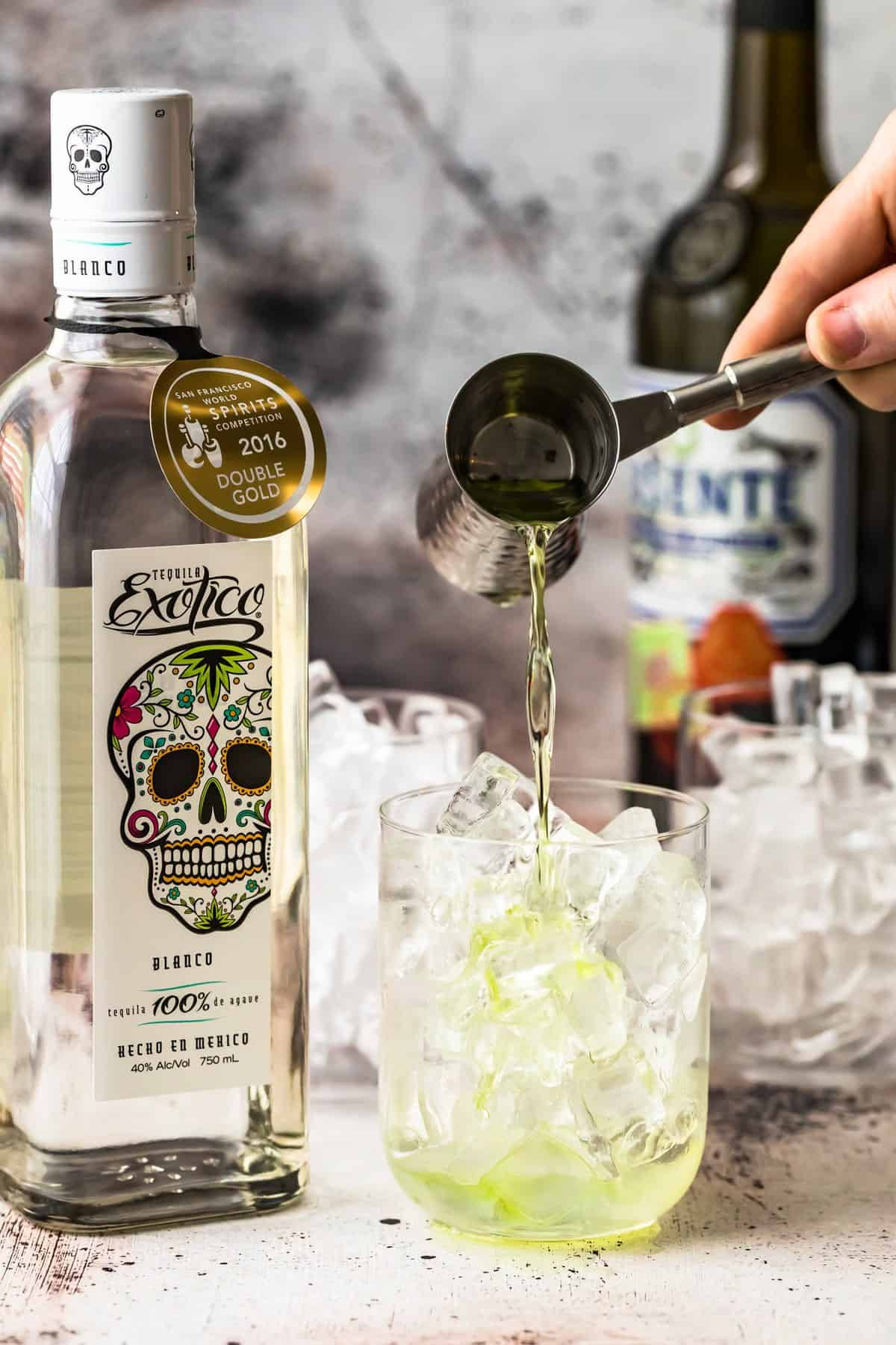Exotico Tequila Perfectly Pouring into a Glass with Ice Wallpaper