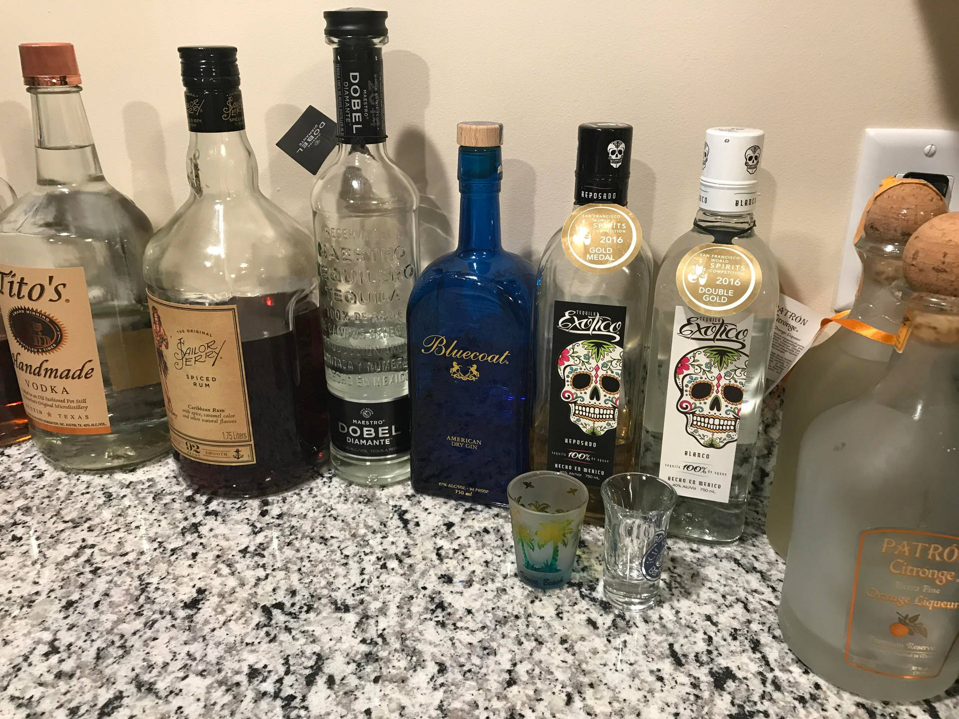 Exotico Tequila With Other Liquor Bottles Wallpaper