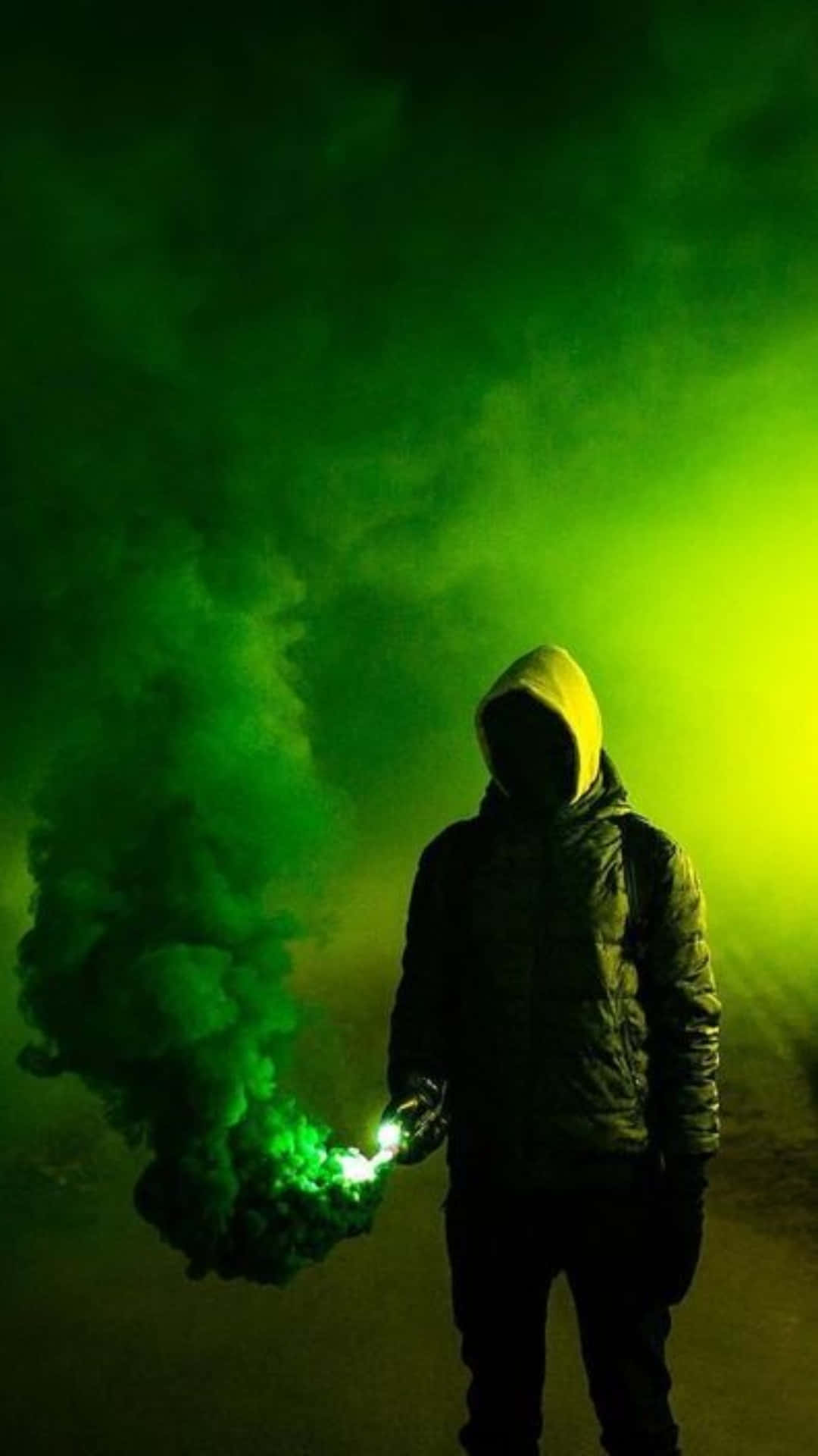 Man Silhouetted Against Green Smoke Explosion Wallpaper