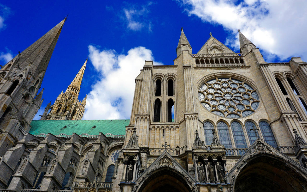 Caption: Majestic Chartres Cathedral against a Blue Sky Wallpaper