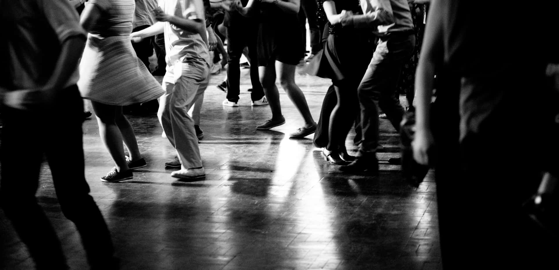 Exuberant Swing Dance Pair In Full Spin Wallpaper