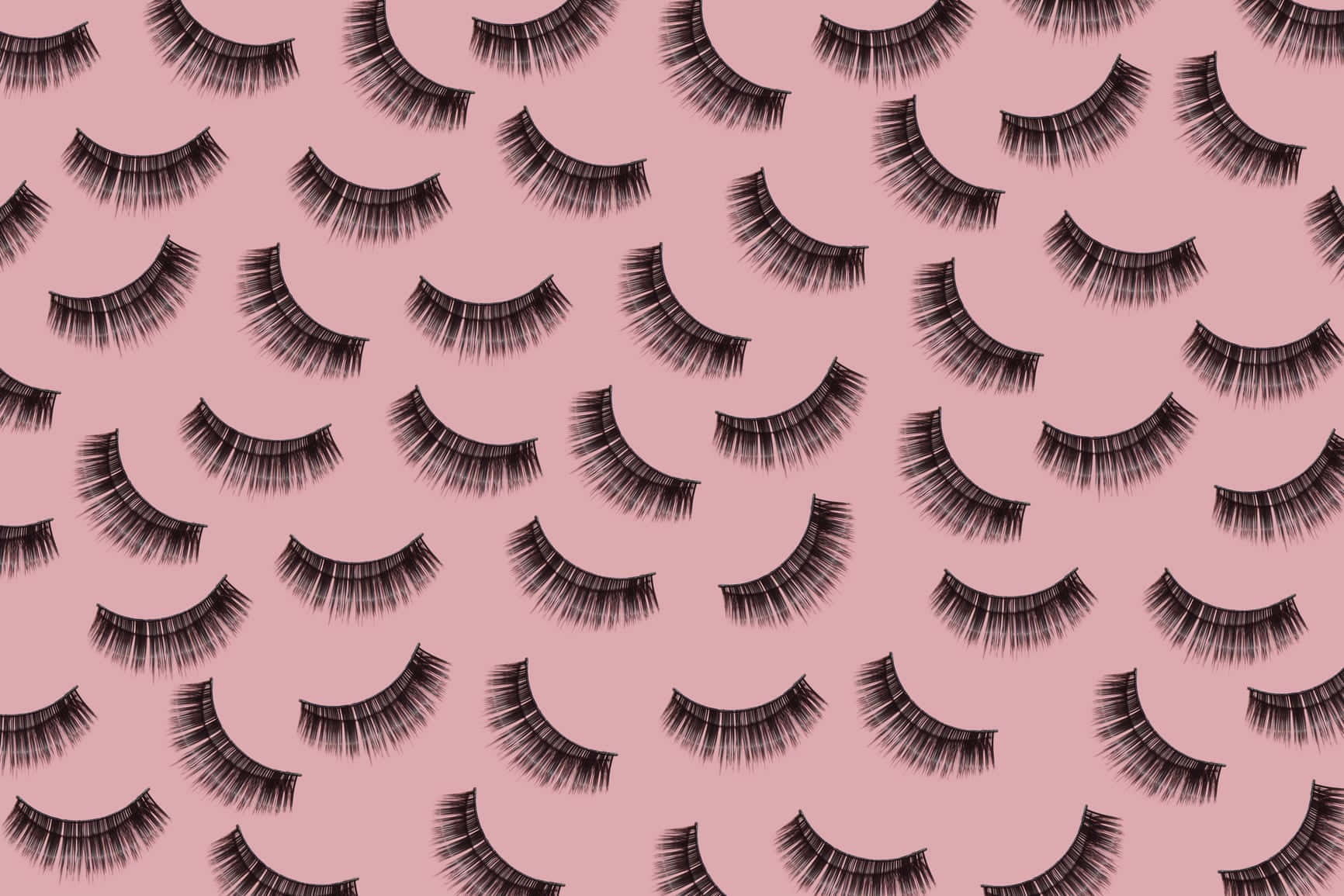 A Pink Background With Black Lashes