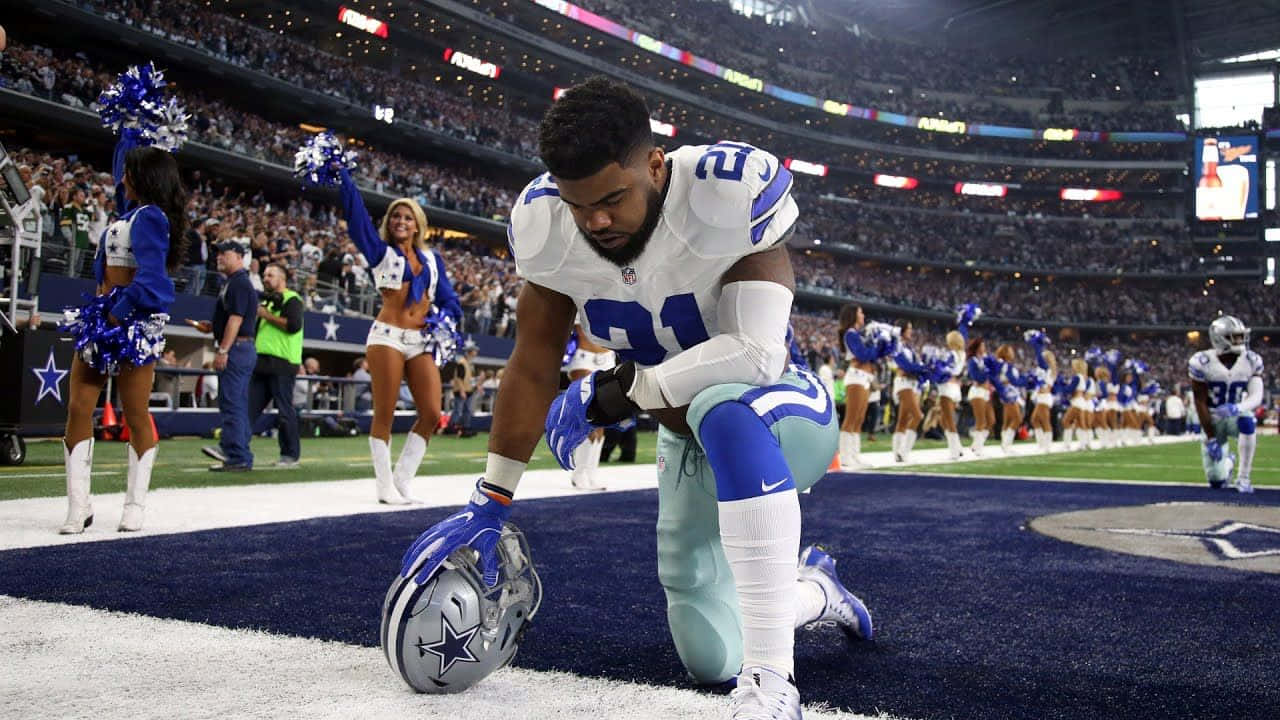 A Cowboy Player Kneeling On The Field Wallpaper