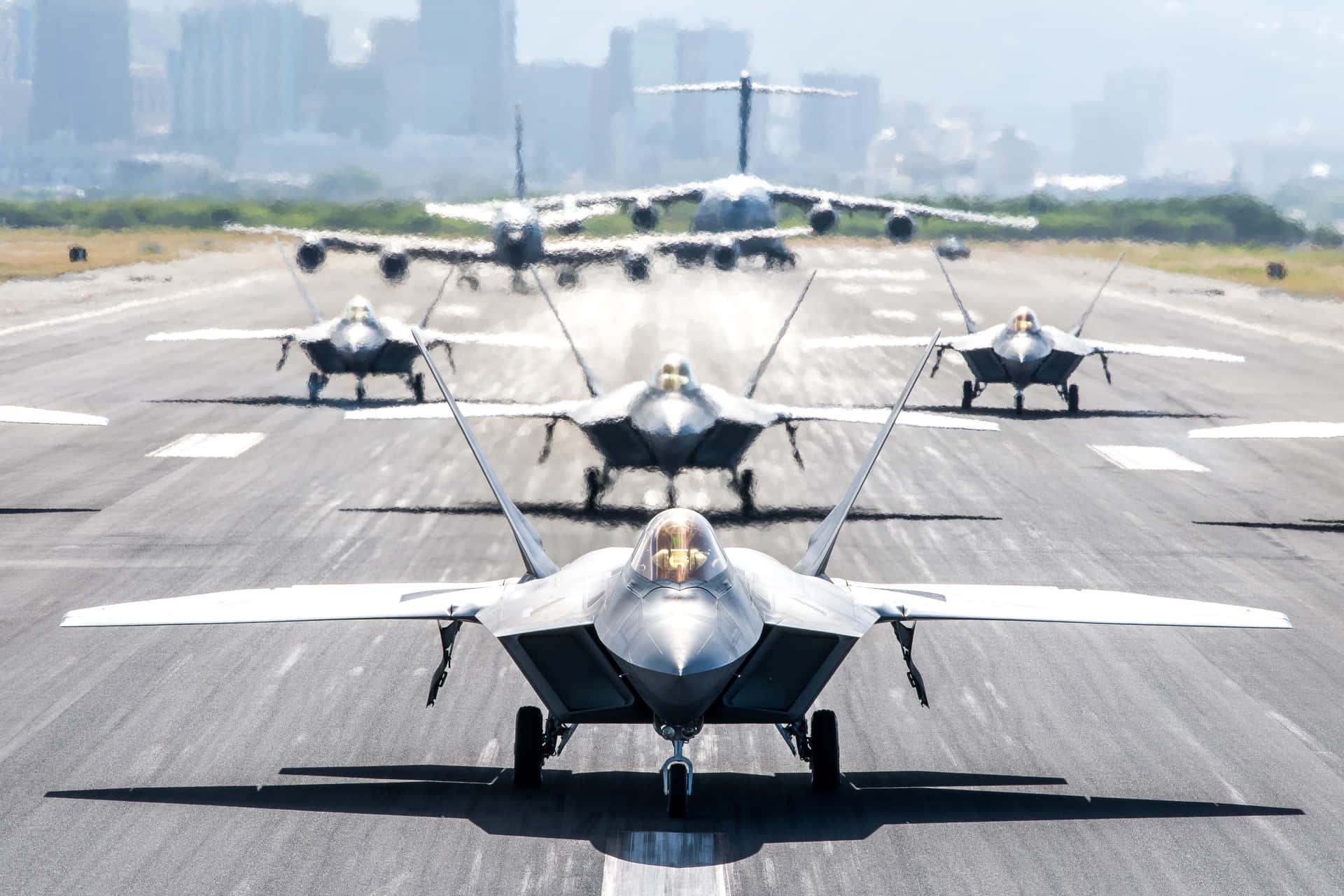 A Group Of Military Jets On A Runway Wallpaper