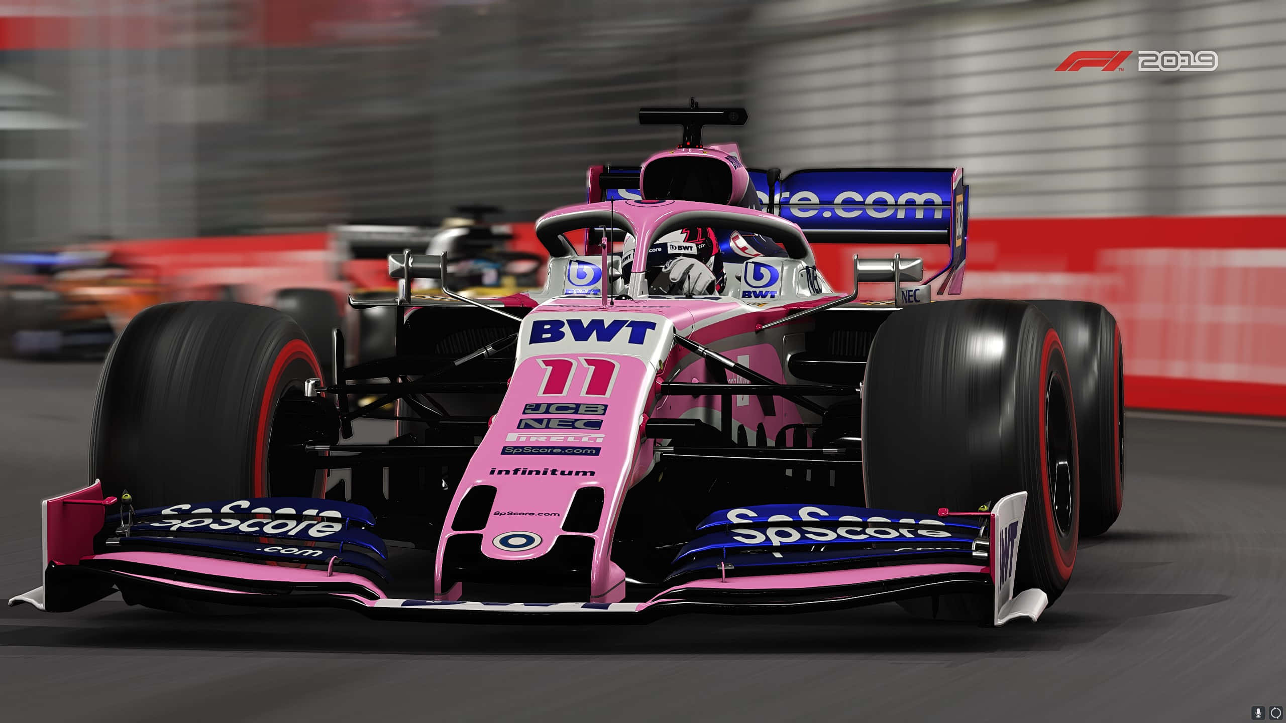 A Pink Racing Car Is Driving Down The Track
