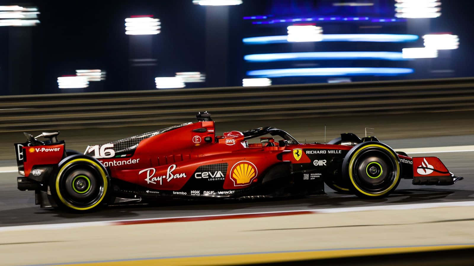Ferrari F1 Car Driving On A Track At Night Wallpaper