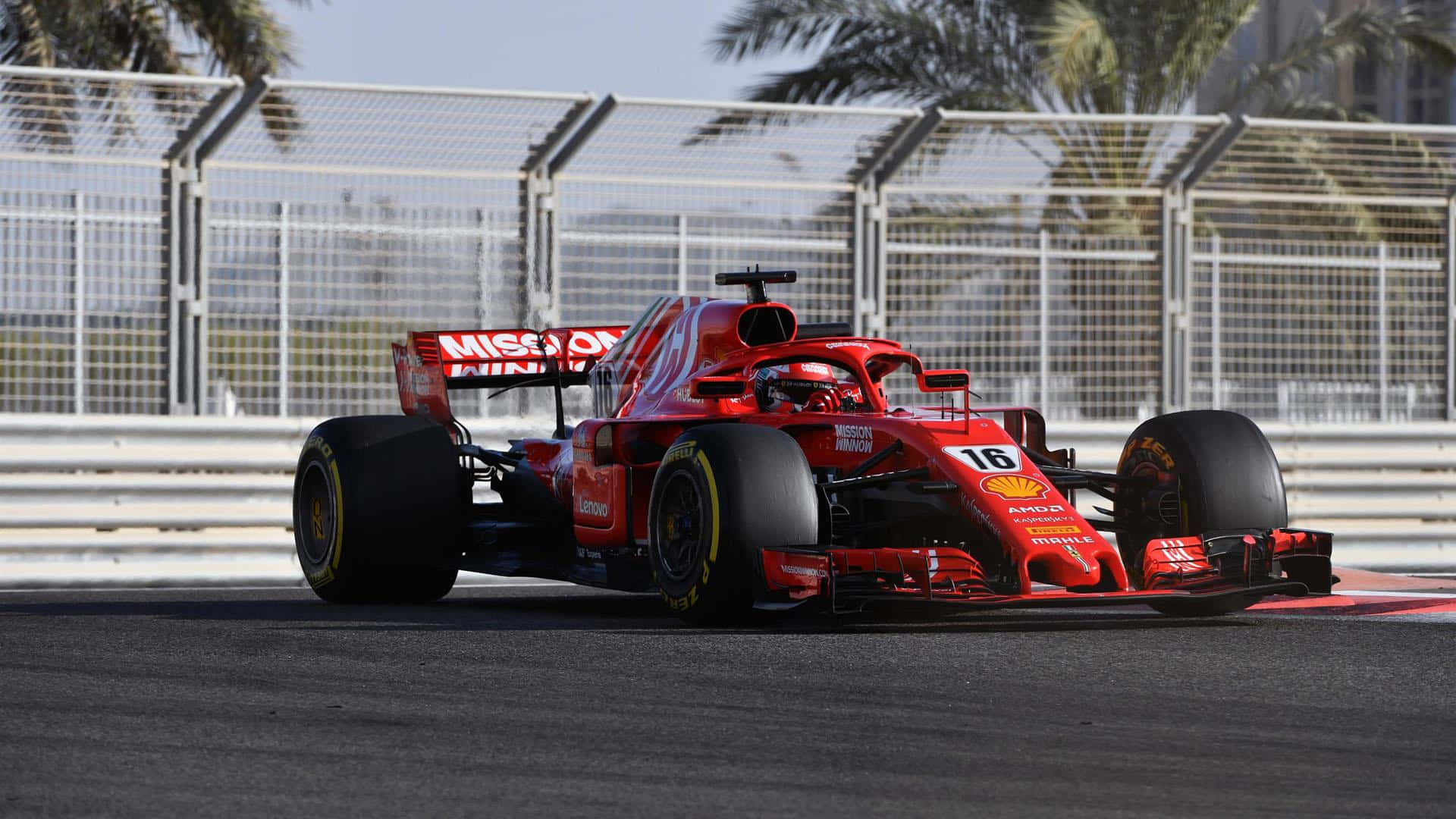 En Ferrari F1-bil kører på en bane vægmaleri Wallpaper