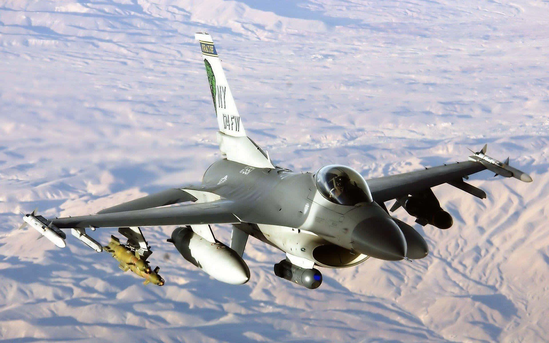 F16_ Fighter_ Jet_ In_ Flight_ Over_ Desert Wallpaper
