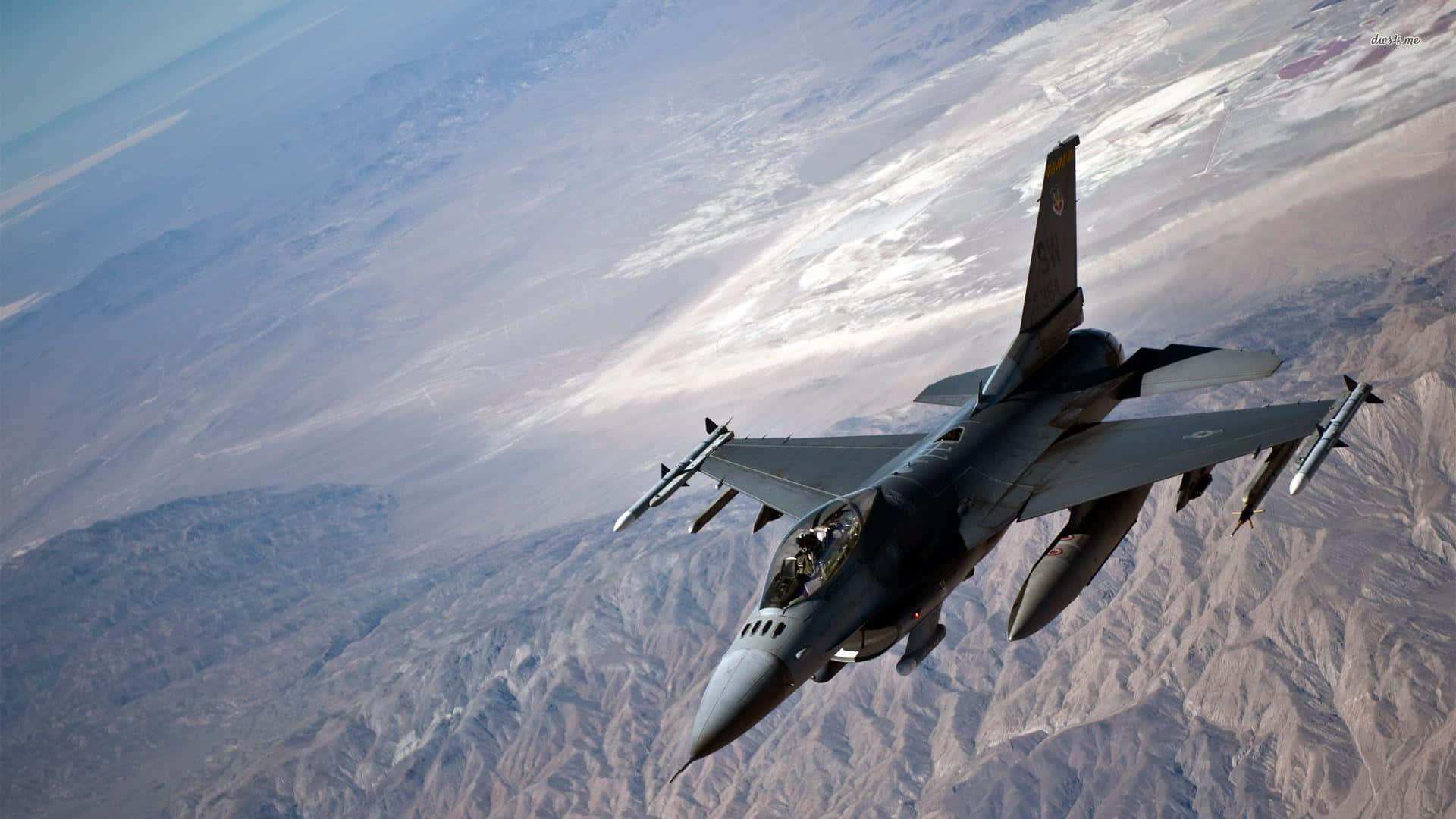 F16_ Fighter_ Jet_ In_ Flight_ Over_ Mountains Wallpaper