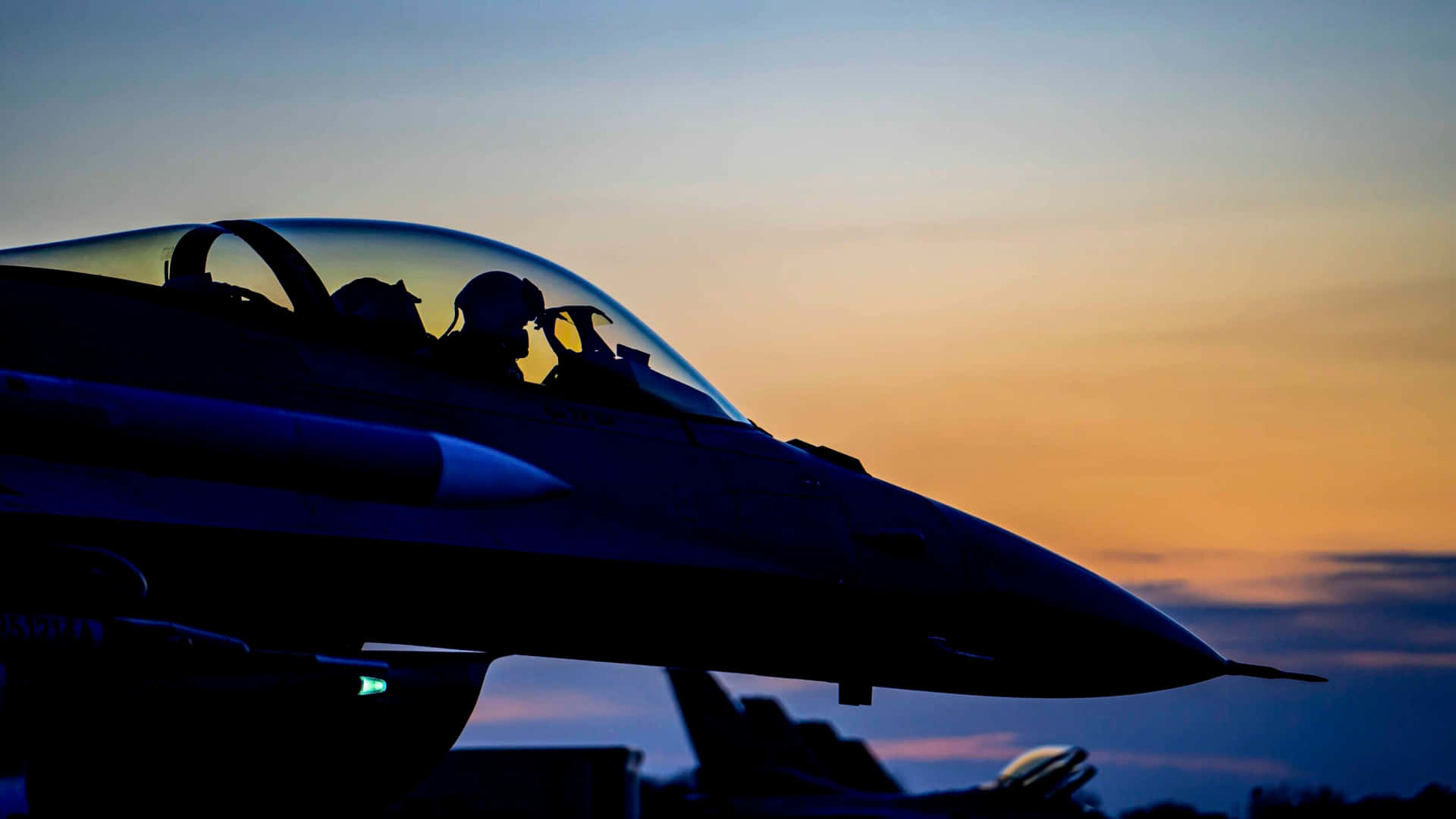F16 Fighter Jet Silhouetteat Dusk Wallpaper