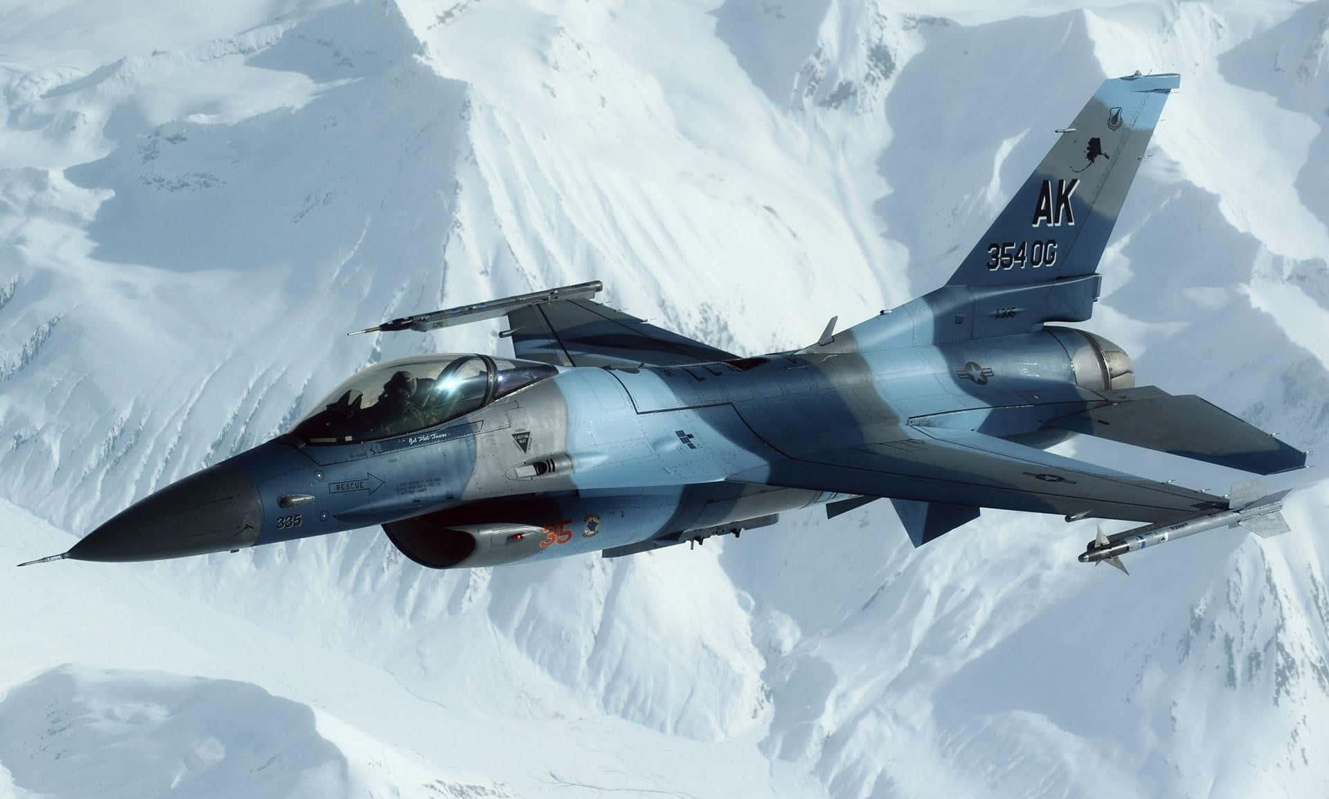 F16 Fighting Falcon Over Snowy Mountains Wallpaper