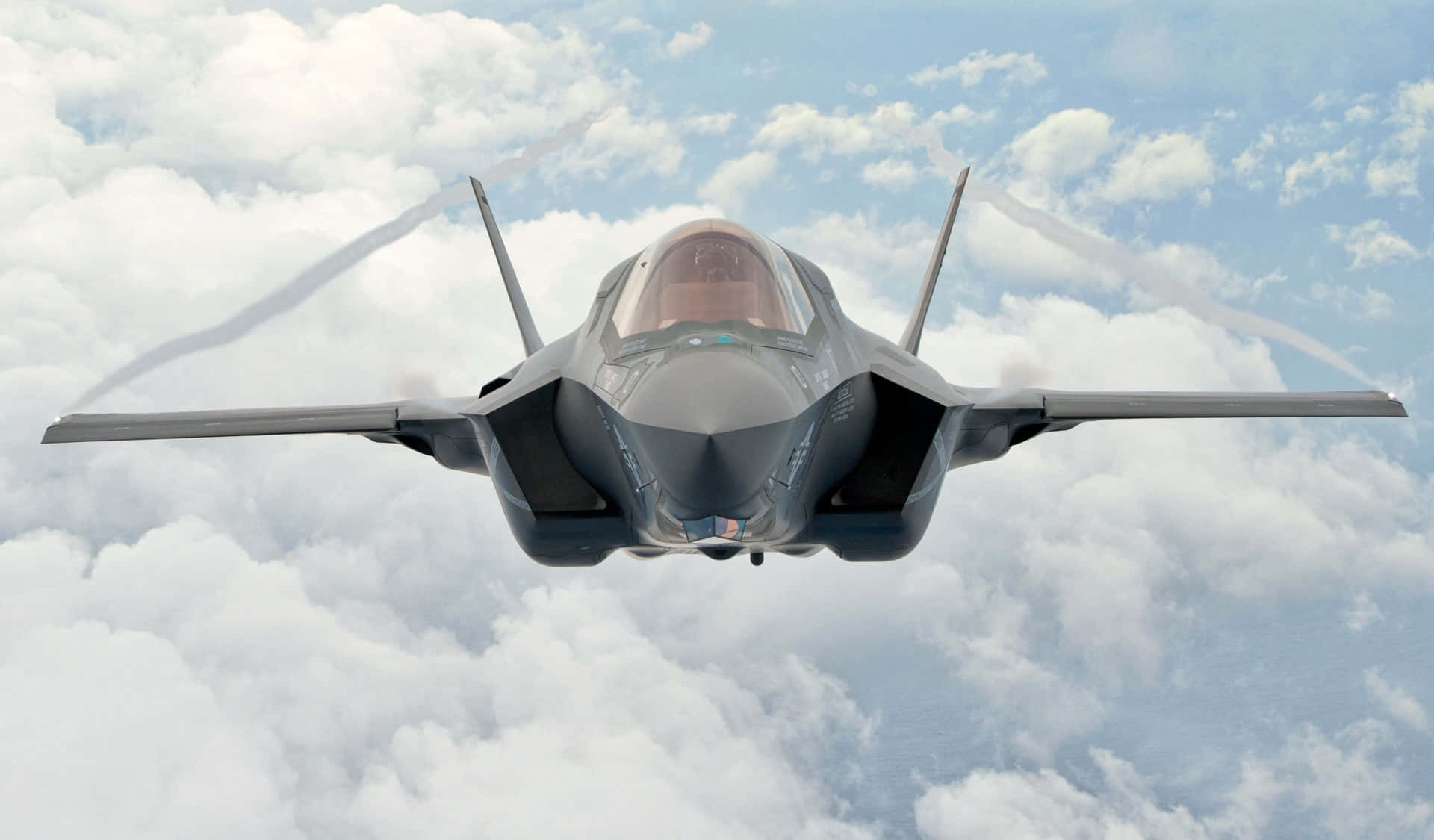 F35 Jet Flying Above Clouds Wallpaper