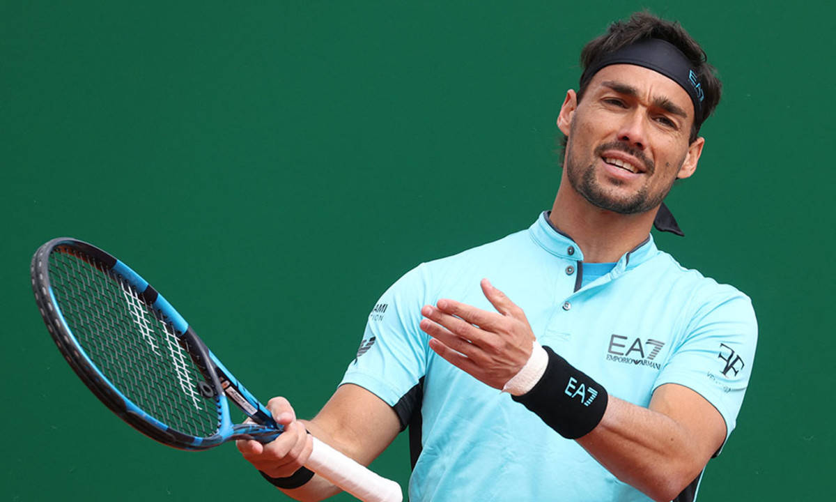 Caption: Fabio Fognini in action on the green backdrop Wallpaper