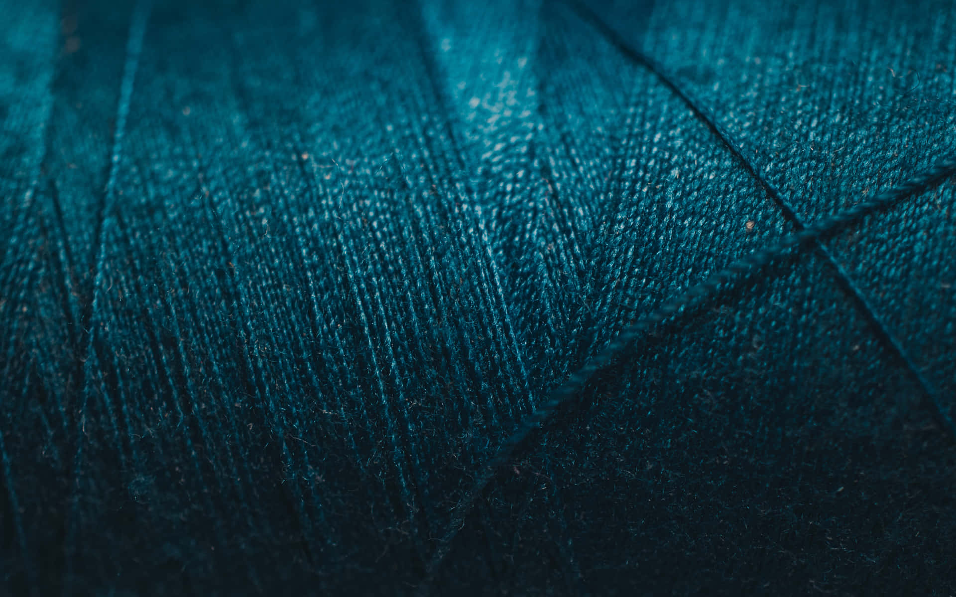 A Close Up Of A Blue Thread
